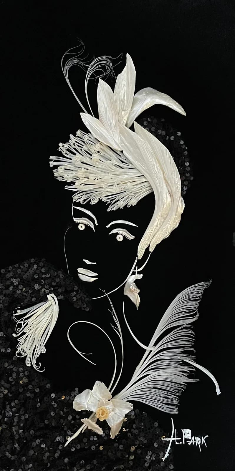 A surreal portrait merges a profile face with flowing botanical forms rendered in ink on black paper.
