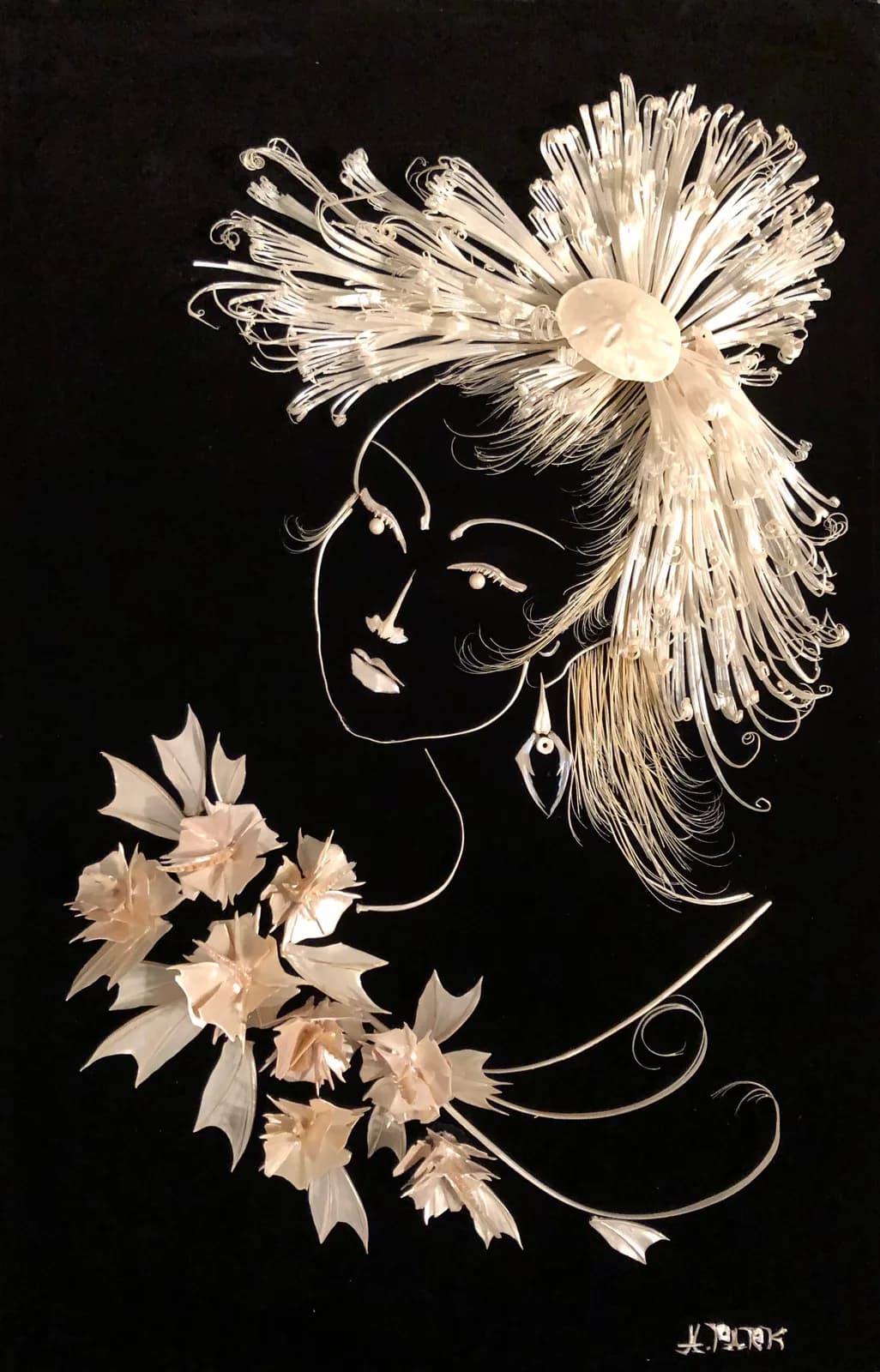 Profile portrait with ink line work and floral hair ornament against black background.