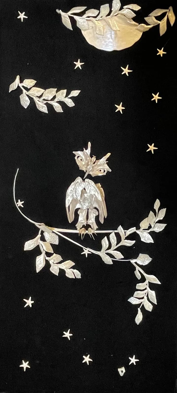 Nocturnal bird perched among branching foliage beneath a luminous moon, rendered in ink and gold on dark paper.