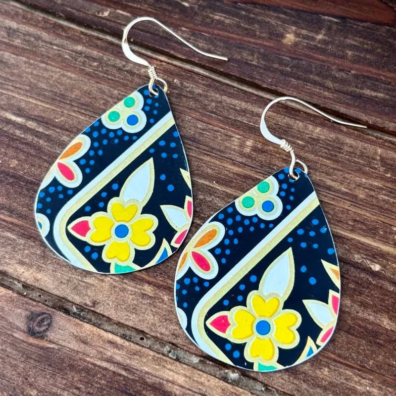 Hand-painted metal teardrop earrings with floral and geometric designs in bright, contrasting colors.