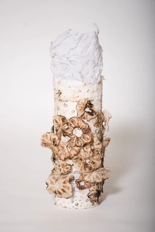 Stacked ceramic sculptural form with organic texture, cream and white glazed surfaces.