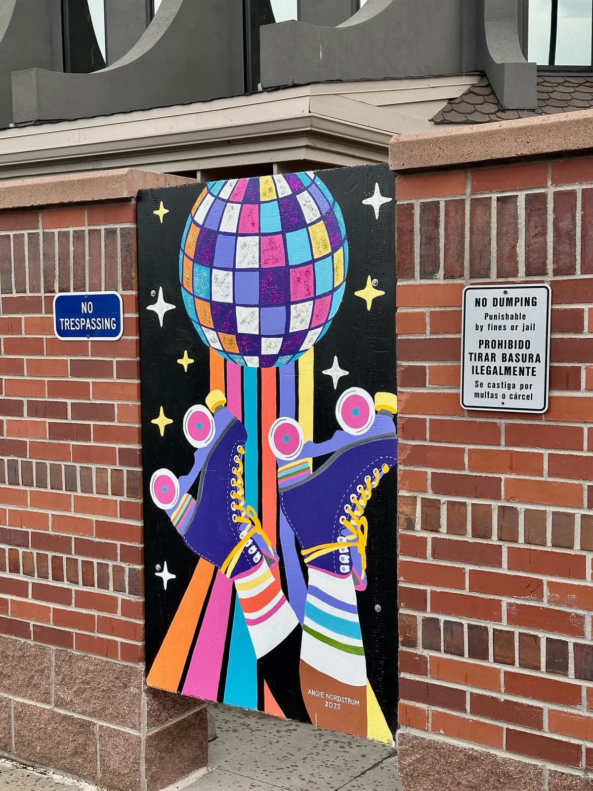 Vibrant street art mural of a disco ball rocket on a brick wall, rendered in bold acrylic colors.
