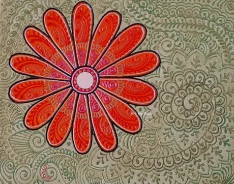 A stylized red flower with patterned petals radiates from a pink center on an ornate background.