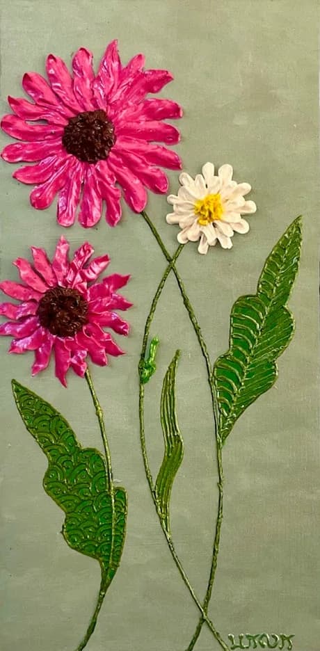 Pink and white gerbera daisies with green stems and leaves on a pale neutral background.