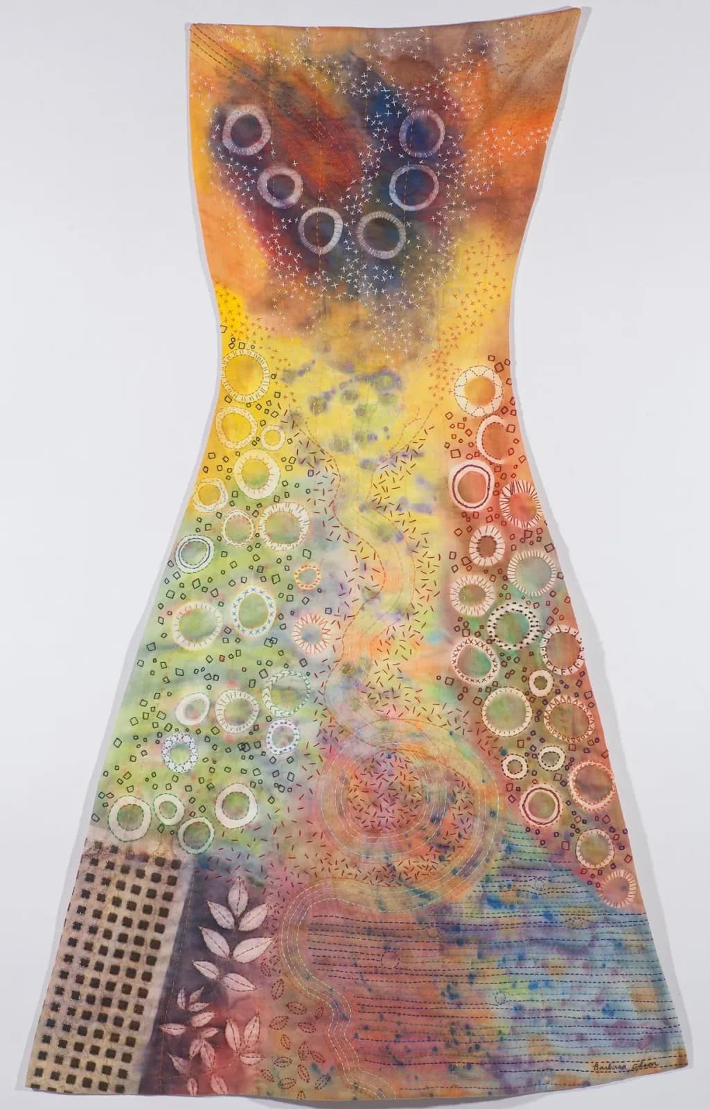Abstract mixed-media dress form with layered circles, collage elements, and warm gradient color palette.