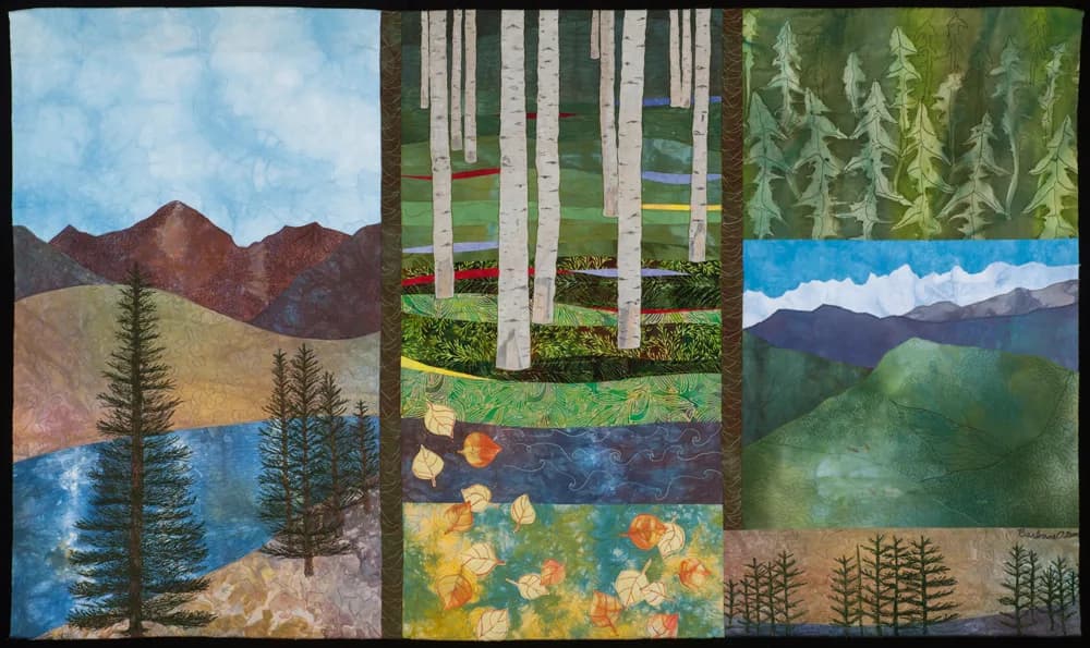 Textile collage depicting landscapes and botanical elements with mountains, birch trees, and stylized foliage.