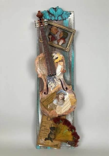 Mixed-media assemblage combining vintage portrait photos, a wooden stringed instrument, decorative elements, and found ephemera on a painted wood base.