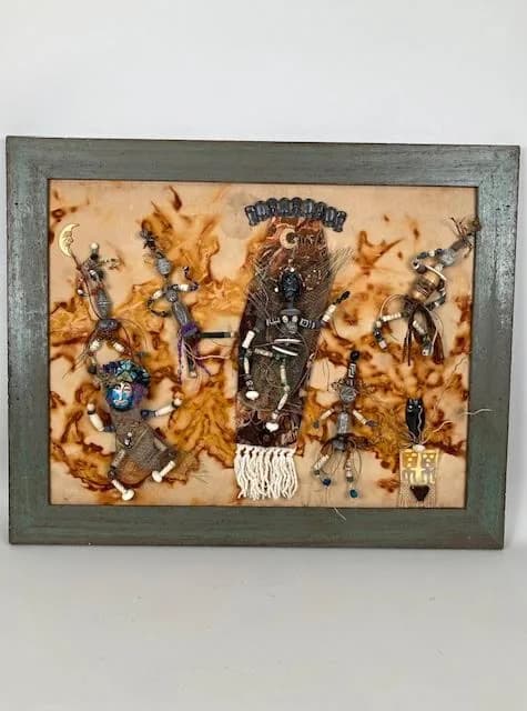 Southwestern kachina-inspired assemblage with textile, beads, and found objects on weathered backing.