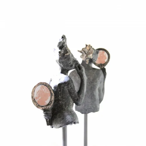 Abstract bronze figures with circular copper elements mounted on stems, contemporary sculptural jewelry.