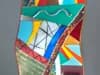 Colorful abstract collage artwork composed of layered and overlapping geometric paper forms.