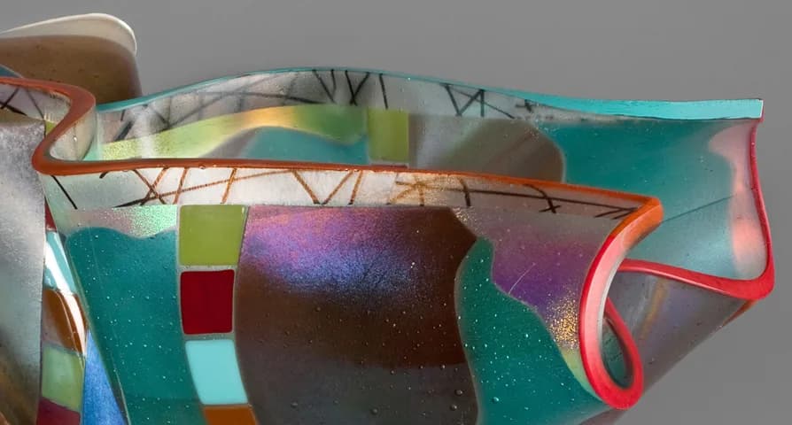 Abstract kiln-formed glass sculpture with layered color fields and curved edges in teal, magenta, and amber.