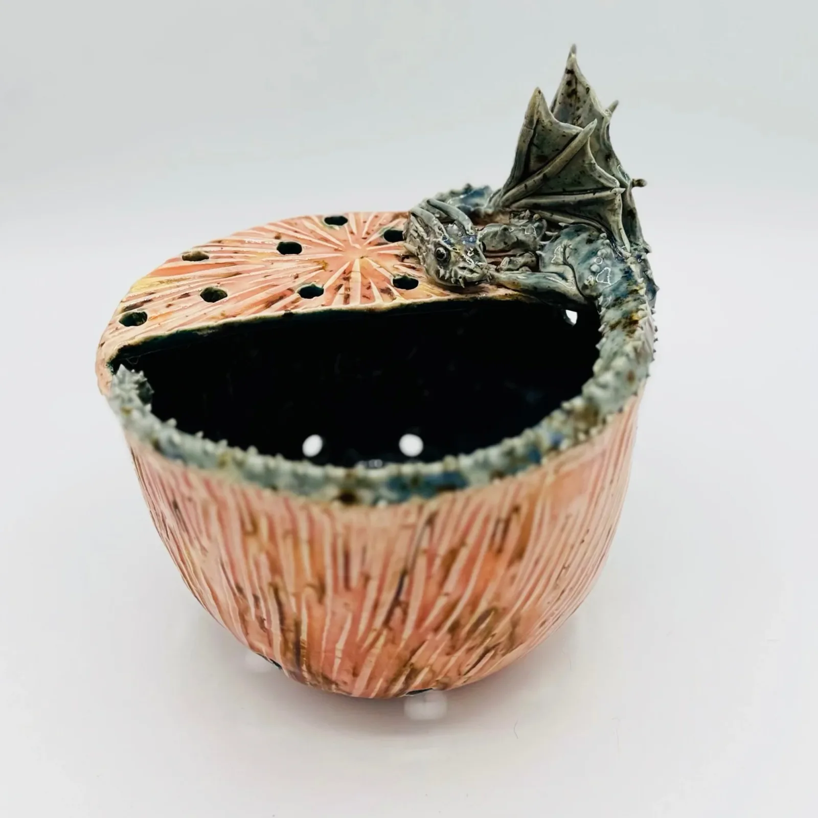 Ceramic vessel with natural seed-pod form, coral and sage glazing, sculptural botanical art object.