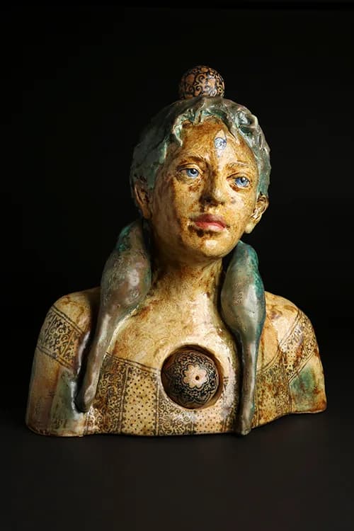 Bronze portrait bust of a figure with distinctive patina and ornamental detailing on the torso.