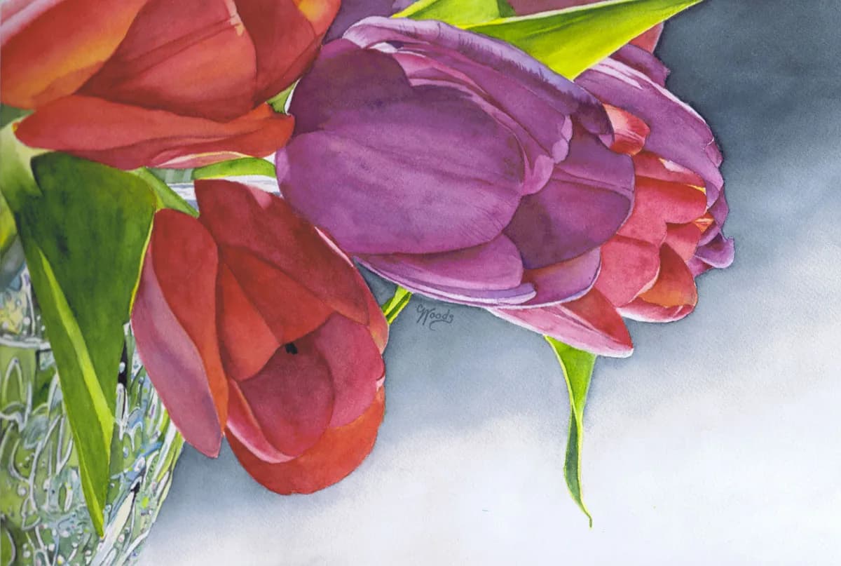 A watercolor arrangement of red and purple tulips in a clear glass vase against a soft gray background.