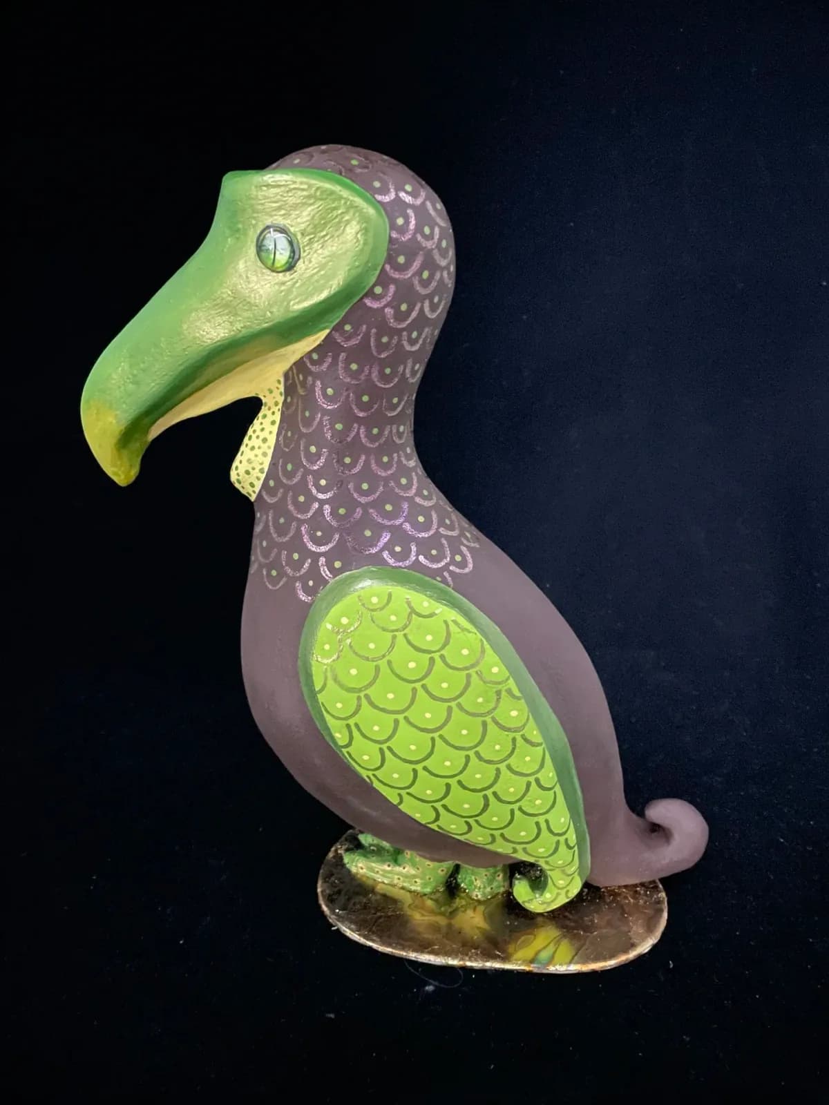 Hand-carved and hand-painted wooden eagle sculpture with green and purple plumage.