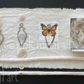 Handmade paper strip featuring embedded insects and natural specimens with a butterfly at center.