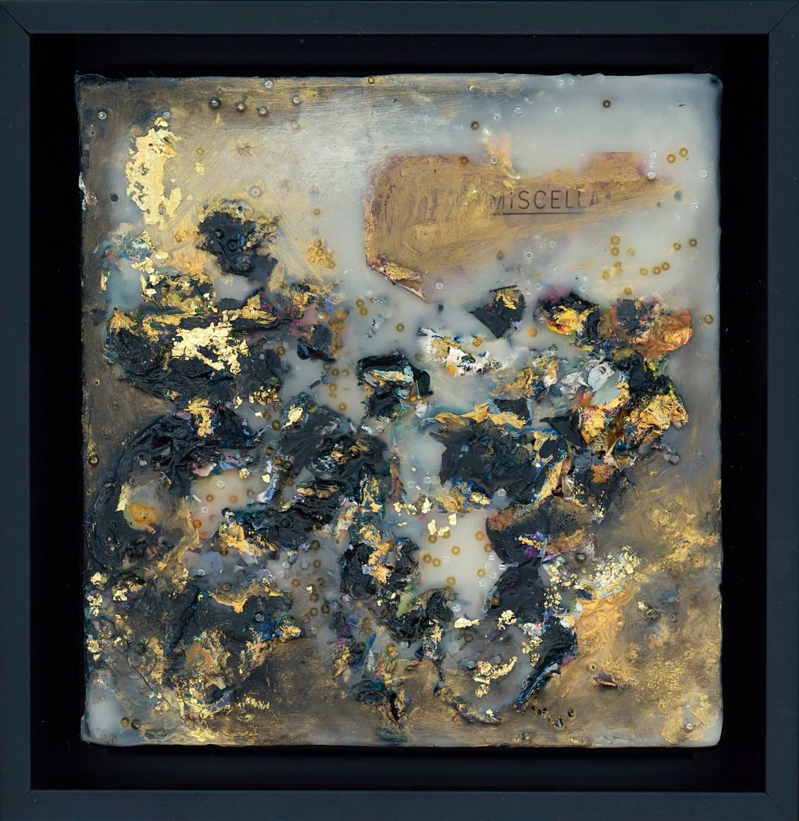 Abstract mixed-media composition with gold leaf, encaustic, and metallic accents on textured surface.