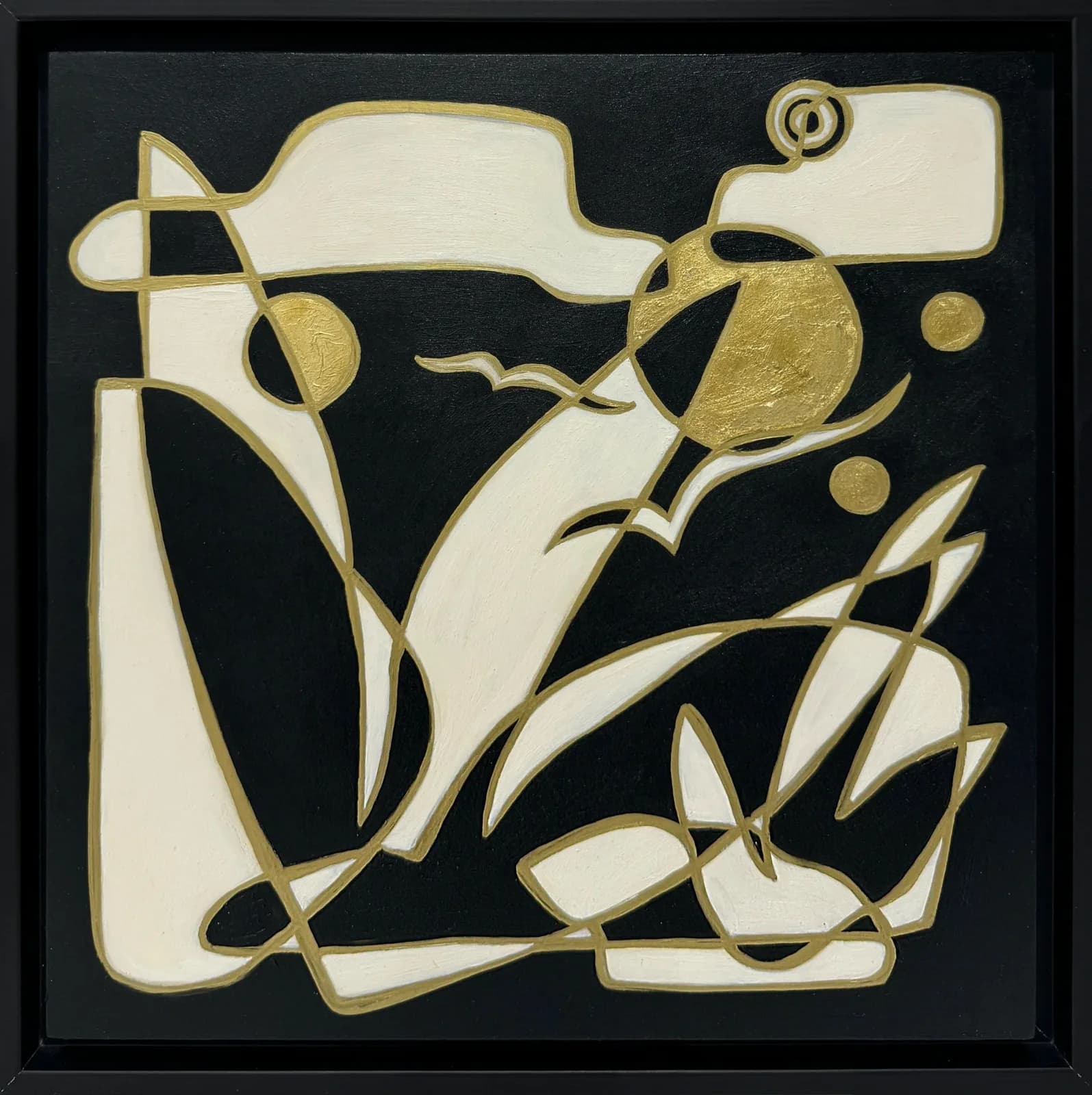 Abstract mixed-media relief with cream and gold geometric forms on black background.