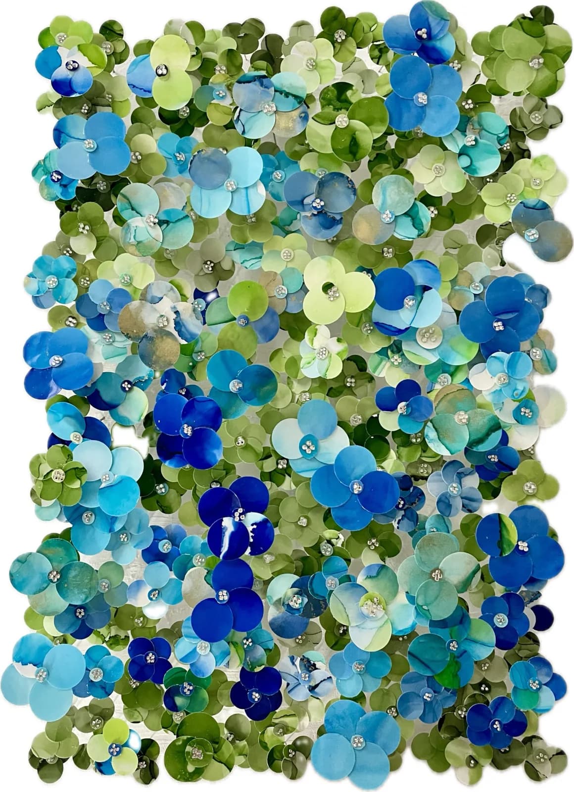 Composition of translucent glass discs in blue, green, and clear tones with metallic accents.