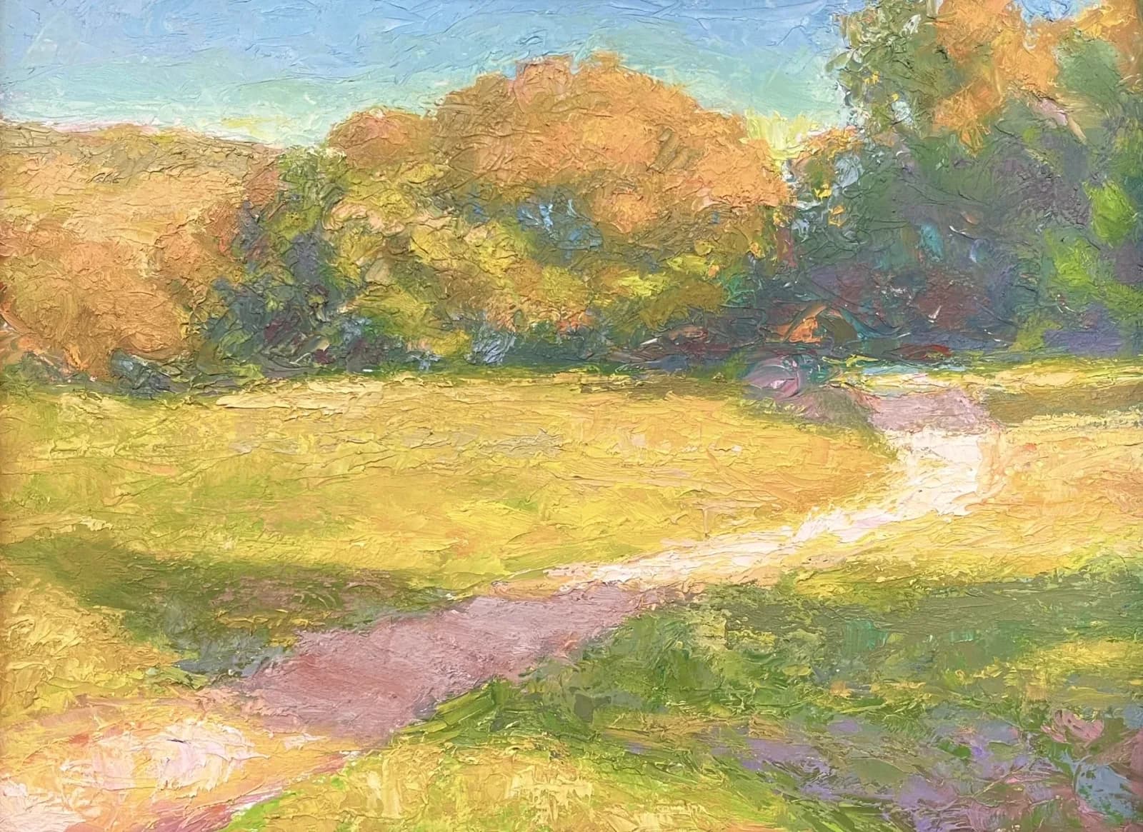 A sunlit meadow with a winding path, golden autumn trees, and soft lavender shadows in oil.