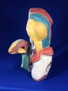 Abstract ceramic sculpture with hand-applied glazes in coral, blue, yellow, and white.