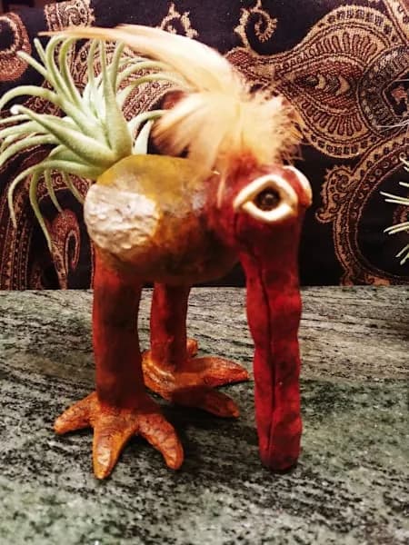Surreal ceramic sculptural assemblage combining pineapple, starfish, and painted clay forms.