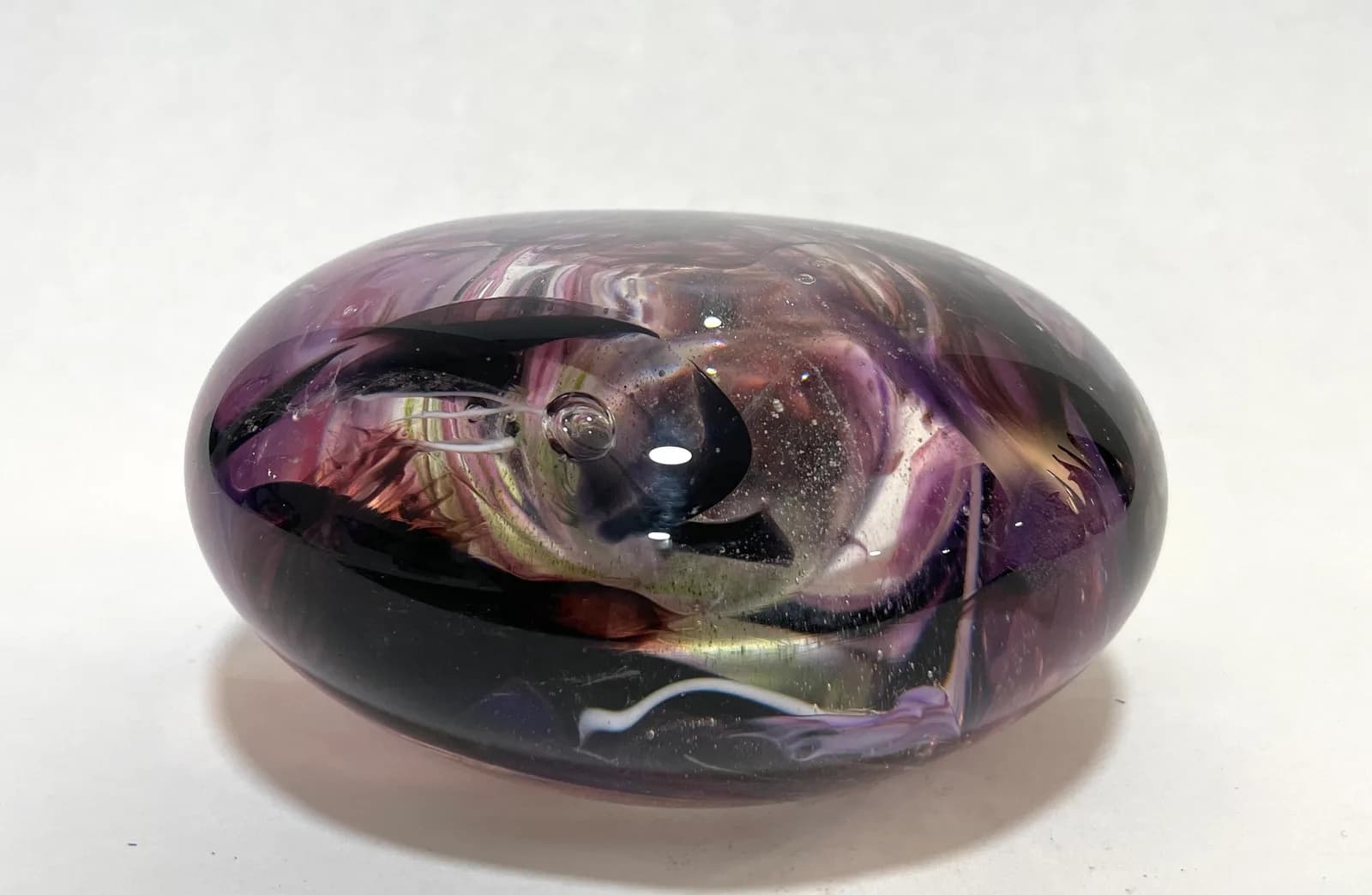 Handblown glass sculpture in purple, brown, and black with organic, ovoid form and internal color variation.