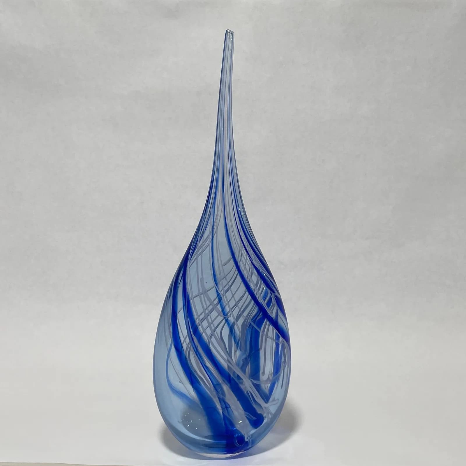 Elegant blue glass teardrop sculpture with internal ribboned details and pointed crown.