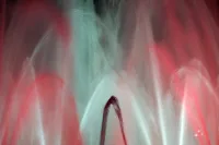 Abstract painting with flowing gestural strokes in red, turquoise, and white on a dark field.