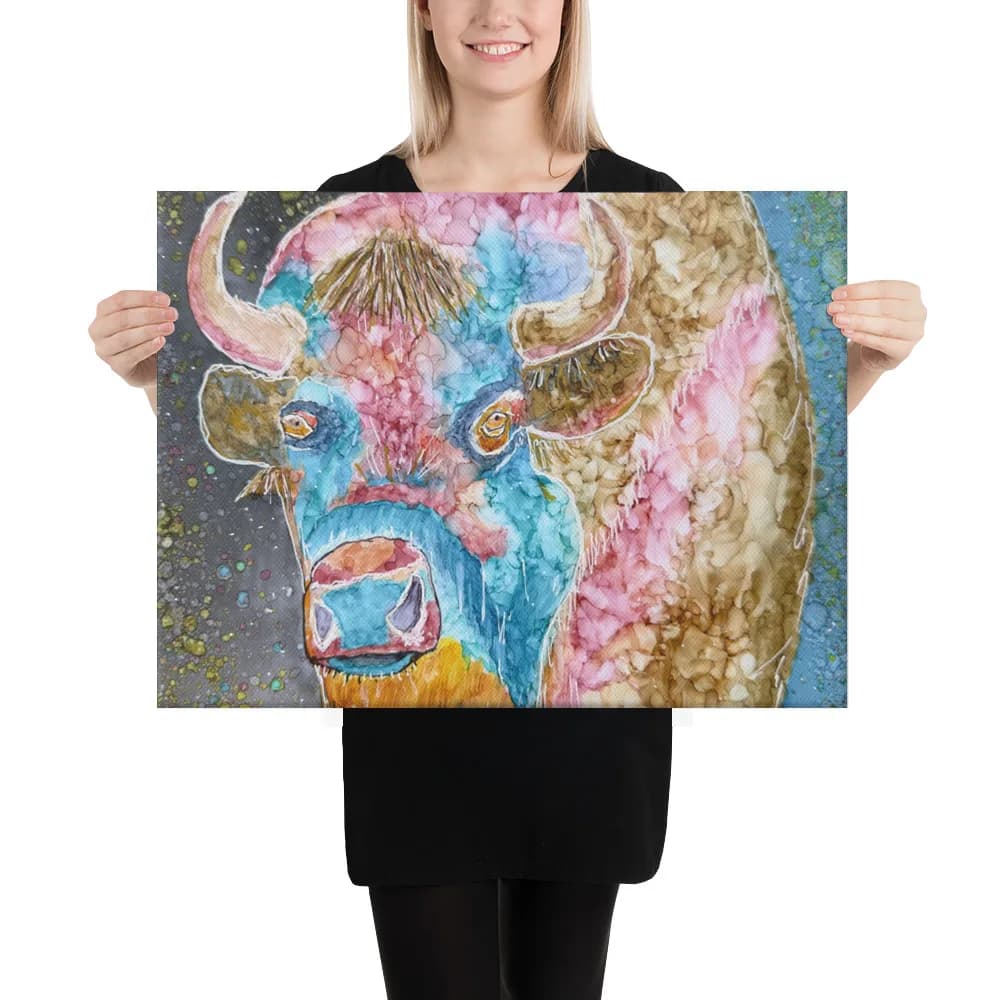 A stylized bull head in watercolor with blue, pink, and gold tones on a spattered background.