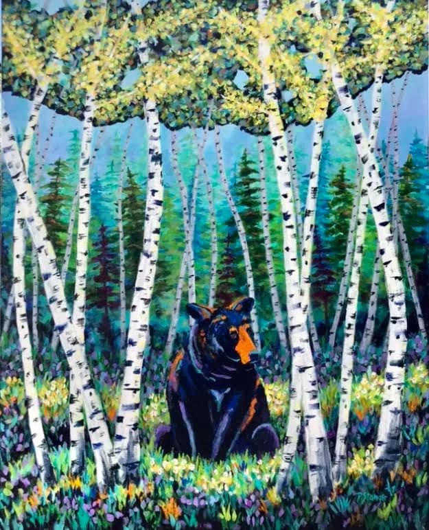 A black bear with golden markings sits among white birch trees and wildflowers in a coniferous forest clearing.