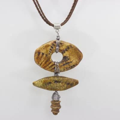 Bronze and patinated leaf-form pendant with organic composition and metalsmith detailing.