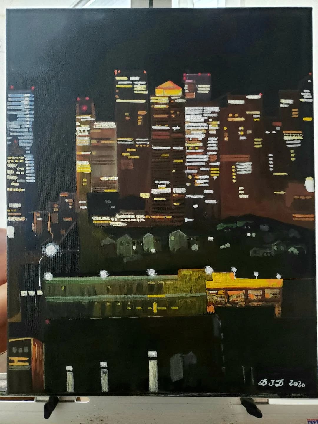 An abstract cityscape with layered buildings, luminous windows, and dark sky in acrylic on canvas.
