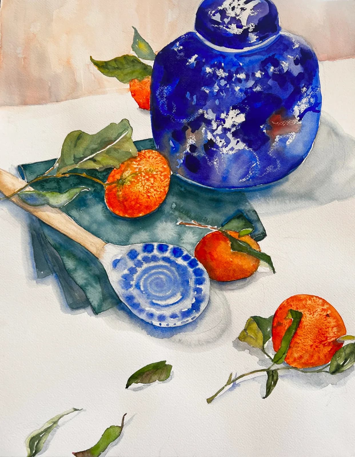 Blue-and-white ceramic vessels with fresh oranges and green foliage arranged on draped fabric in watercolor.