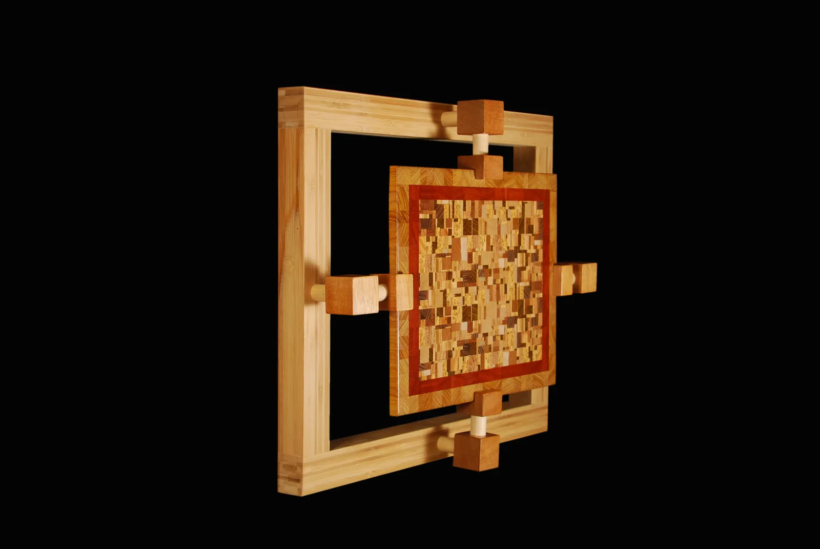 Three-dimensional wood assemblage with geometric mosaic panel and articulated frame, multiple wood tones.