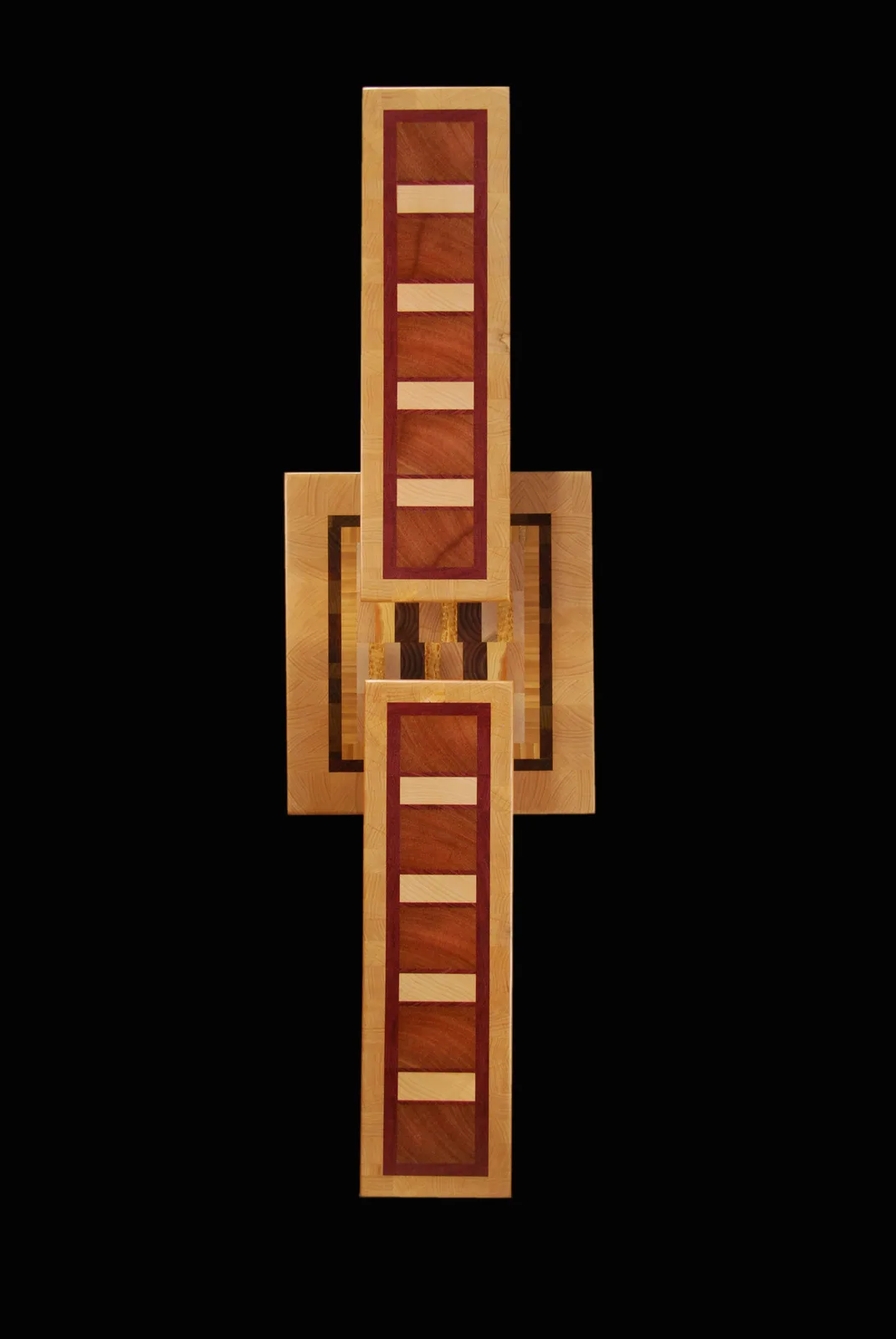 Geometric wood cross with inlaid burgundy and light wood stripes, centered with a square motif.