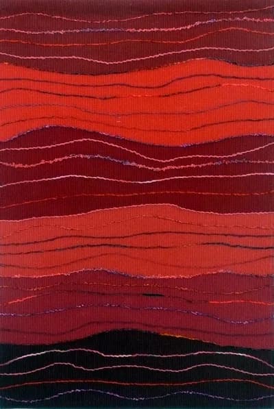 Abstract textile composition in layered red, orange, and dark tones with stitched linear details.