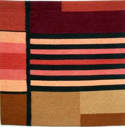 Abstract geometric composition in red, black, tan, and brown woven fiber art.