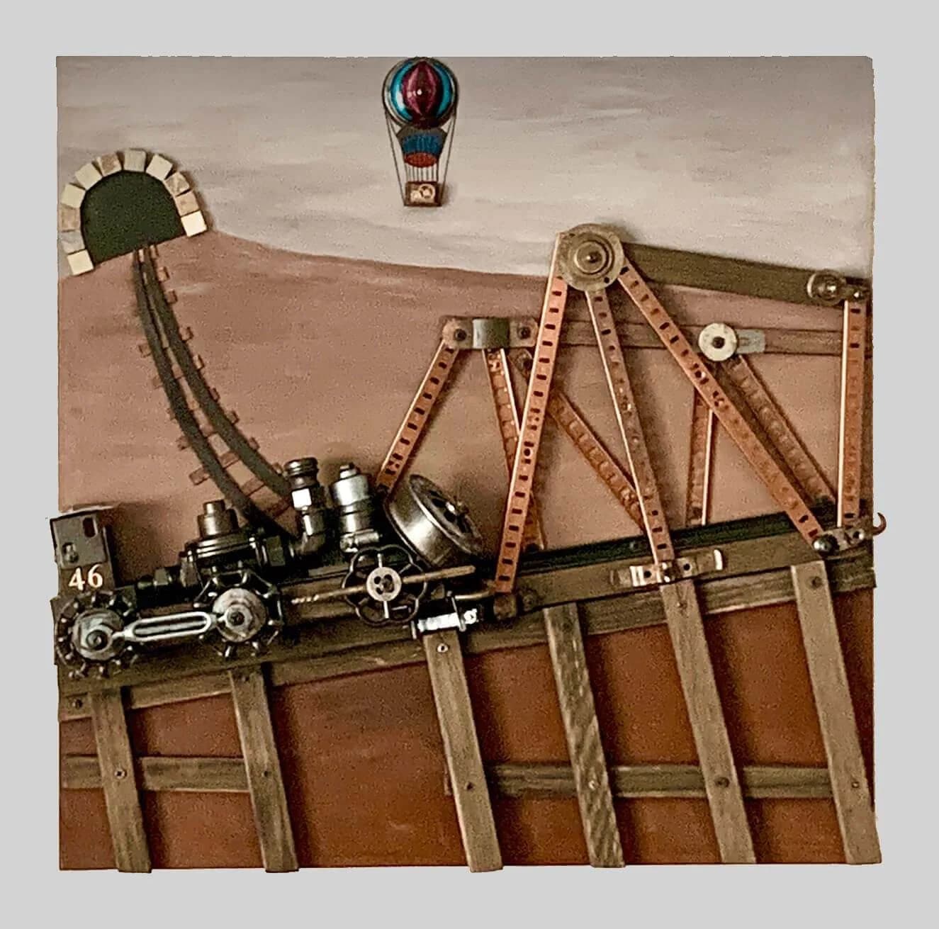 Surrealist assemblage combining a toy locomotive, hot-air balloon, and salvaged metal objects against a stylized desert landscape.