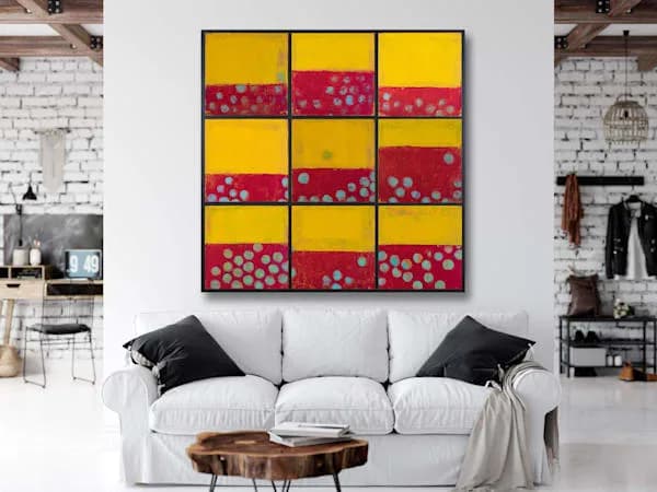 A nine-panel abstract grid artwork in yellow, red, and gray with circular motifs in acrylic or mixed media.