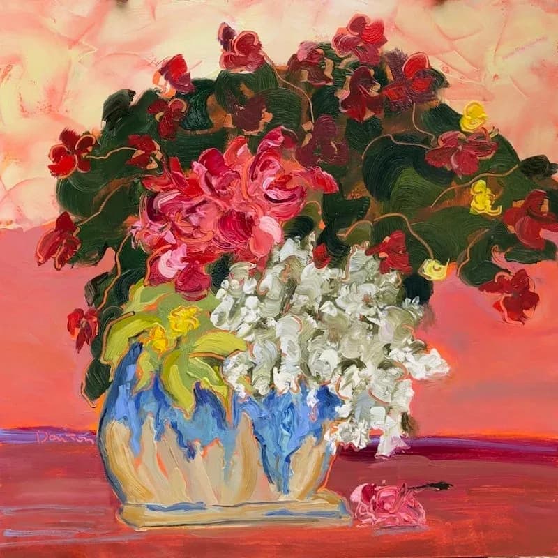 Oil painting of red and pink geraniums in a blue and yellow ceramic vase against a warm coral background.