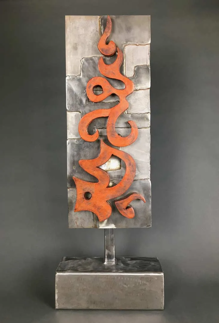 Abstract welded metal sculpture with bright orange organic forms mounted on a grey block base.