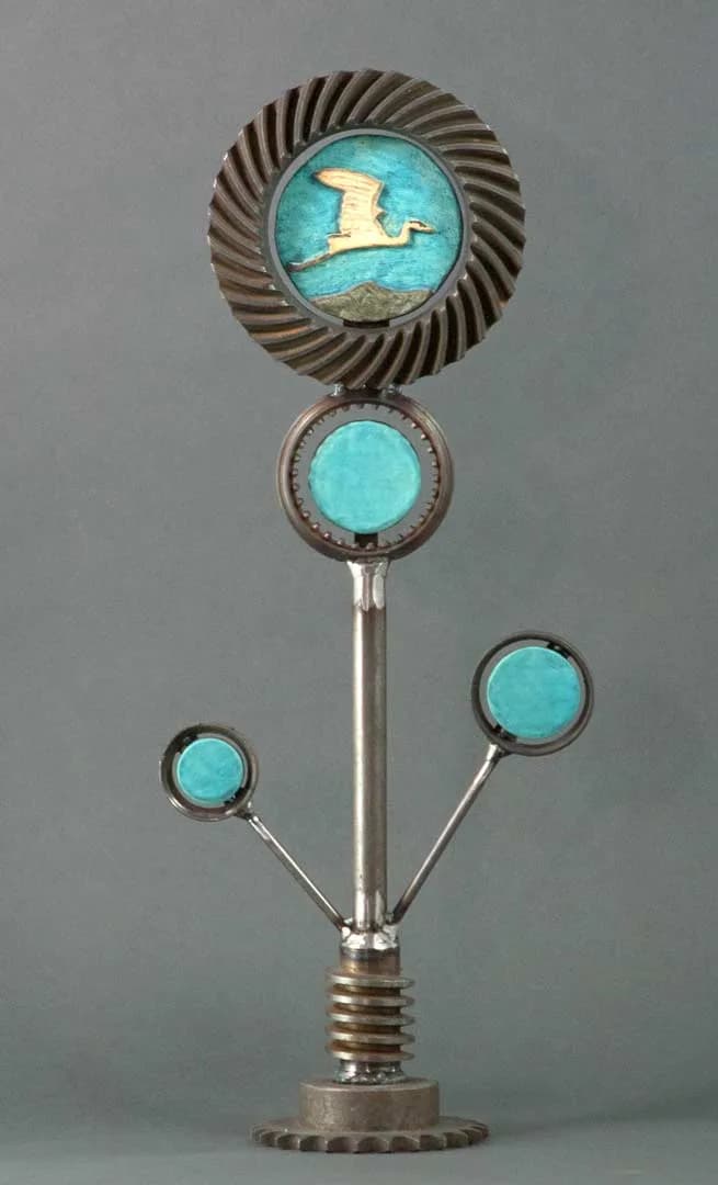 Modernist brooch with turquoise enamel, metal gear, and bird motif on articulated stem.