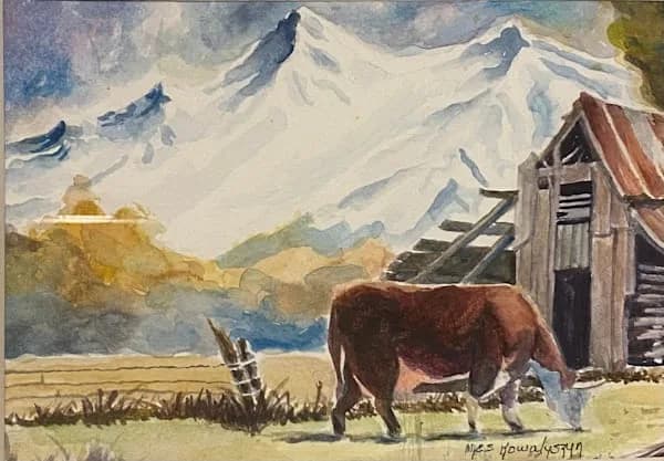 A brown cow grazes near a weathered ranch building under snow-capped mountains in this watercolor frontier scene.