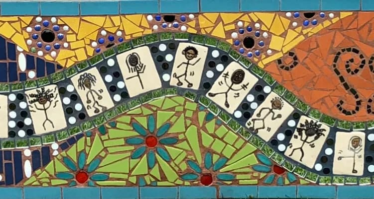 Mosaic mural with stick figures, flowers, and polka dots in Anzac blue, Celery, and Cape Cod tones.