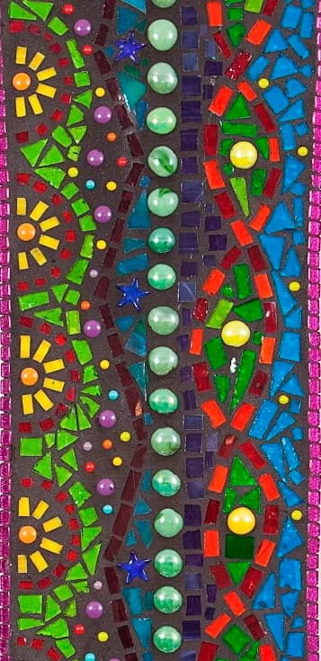 Colorful mosaic composition with radial geometric patterns, glass spheres, and apple-green, blue, and matterhorn tiles.