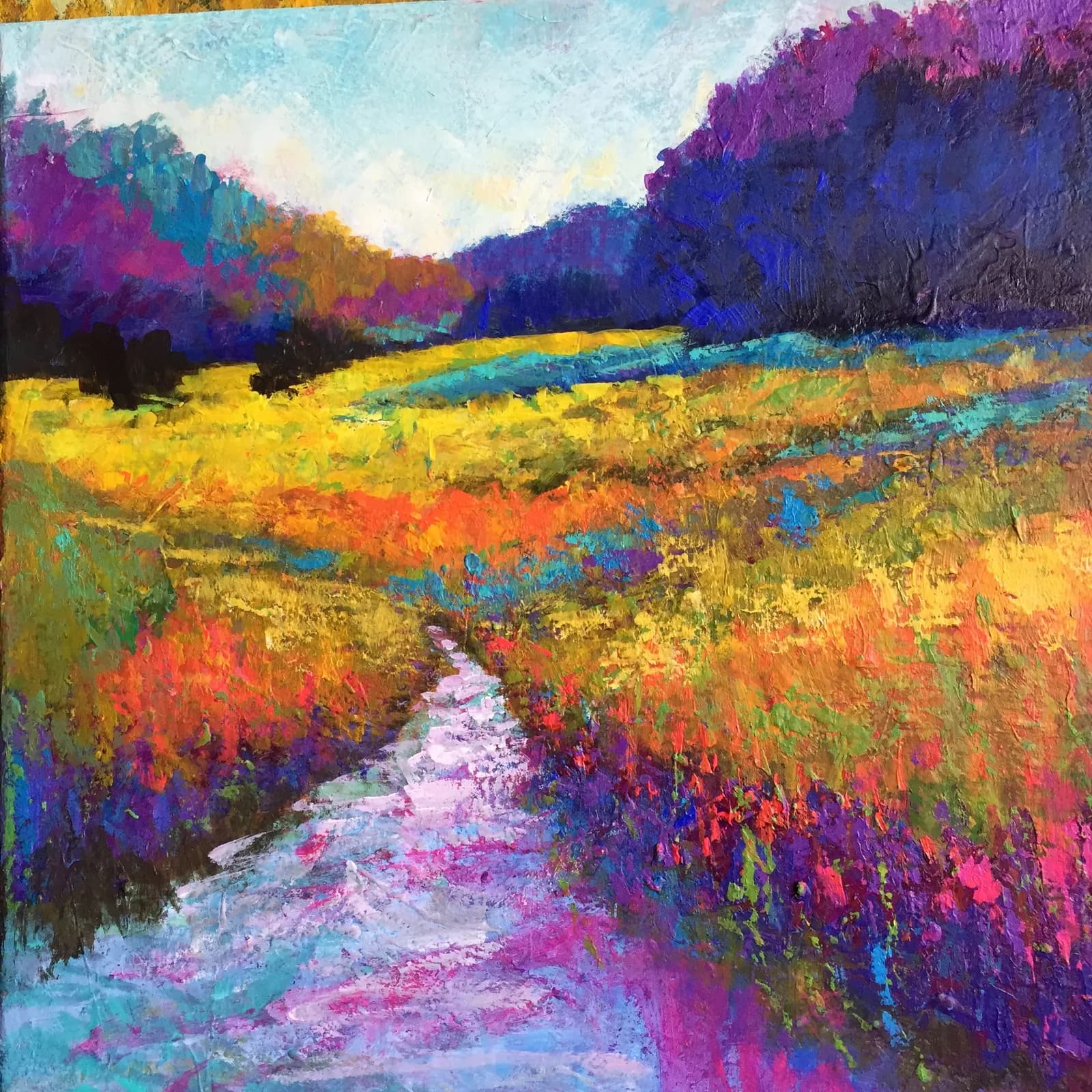 A vibrant impressionist painting of a wildflower-filled meadow with a winding stream and distant mountains in plum, geyser, and tulip-tree hues.