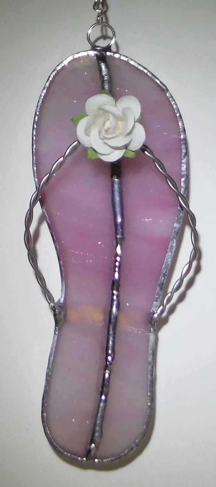 Wire-wrapped amethyst pendant with a ceramic rose accent and beaded detail.