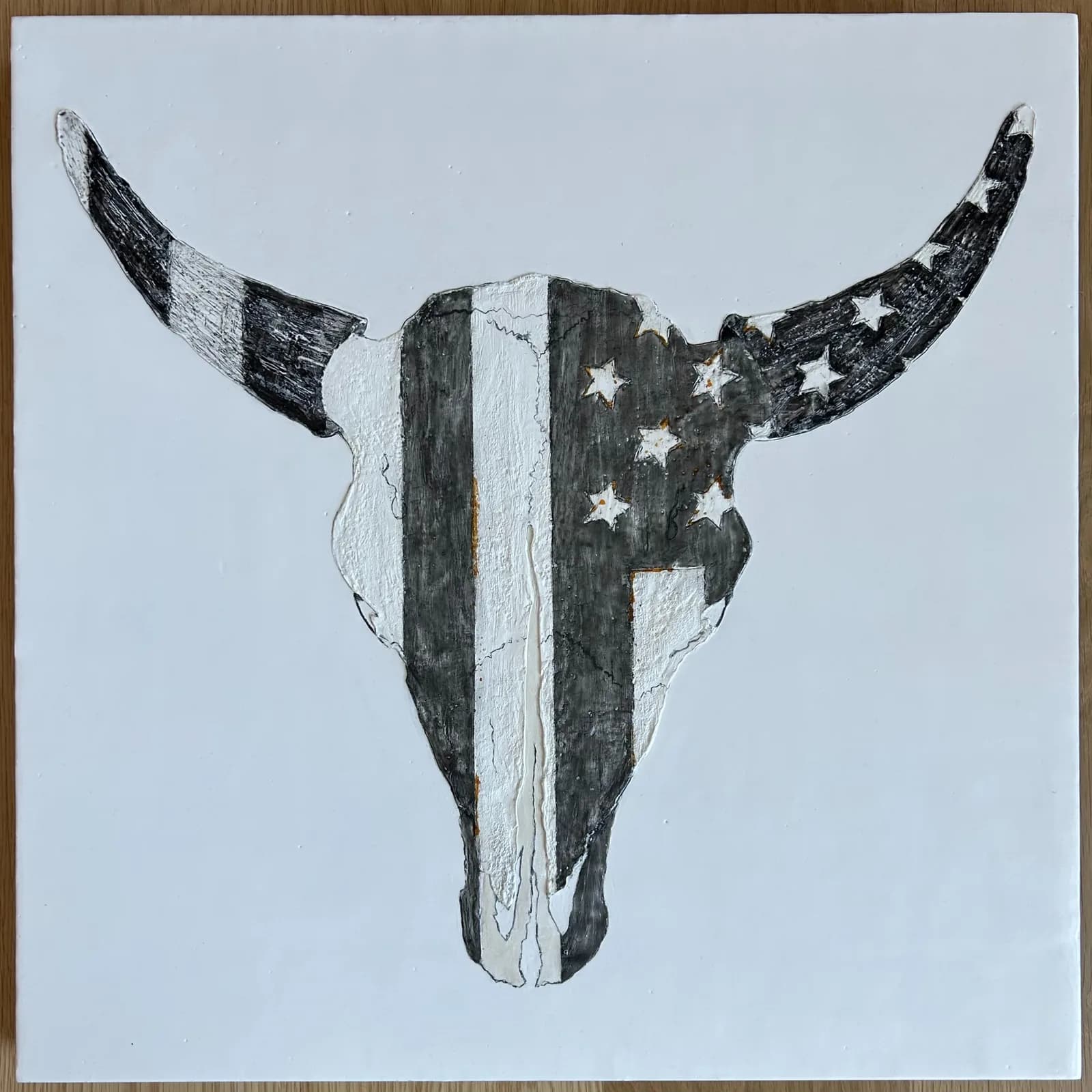 Bull skull painted with American flag stripes and stars in mixed media on paper.